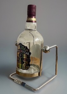 lot 46 image: Highly Collectible 12-year-old Chivas Regal Scotch Whiskey Bottle, 4.5 liters, Empty, with Cradle