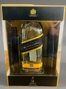 lot 47 image: Highly Collectible Empty 12-year-old Johnnie Walker Black Label Blended Scotch Whiskey Bottle Presented in a Customized Cradle