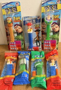 lot 244 image: Seven (7) Toy Story Themed PEZ Dispensers - Including Woody, Buzz Lightyear, &amp Rex