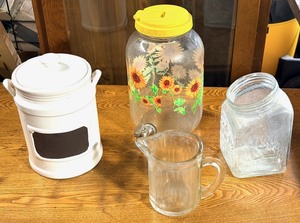 lot 220 image: Sunflower Themed One Gallon Beverage Dispenser, Vintage 1951 Bloomfield&nbspRibbed Glass PitcherSyrup Dispenser, &amp Vintage Ceramic and Glass Canisters