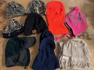 lot 299 image: Nine (9) Cold Weather HatsHead Covers - Including Winchester, Remington, and Real Tree Camo Beanies, Tenergy Beanie, Three Hole BalaclavaSki Mask, &amp Womans Calvin Klein Beanie