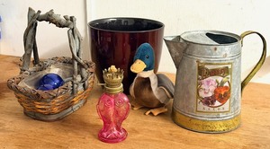 lot 301 image: Vintage Pansy Seeds Corrigated Steel Watering Can, Bentwood Basket and Three (3) Hand-Blown Glass Orbs, Vintage Pink Fish Glass Oil Lamp, Border Burnt RedMaroon 6 Border Solutions Ceramic Planter, & Plush Mallard Duck