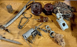 lot 304 image: AntiqueVintage Items - Including Dog Safe Raccoon Trap, Insulators, Railroad Spike, Metal Tongs, & Antique Wooden Pestle Head