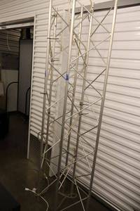 lot 26 image: Pair of triangular aluminum trusses with rope lights