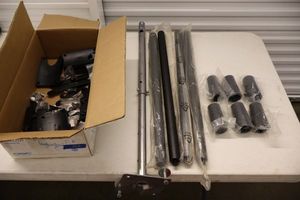 lot 102 image: Table legs, mounting bar, and more