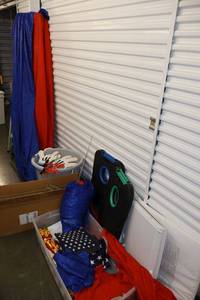 lot 101 image: Red and blue Silky fabric backdrops, folding corn hole sets, yard sign frames, flags