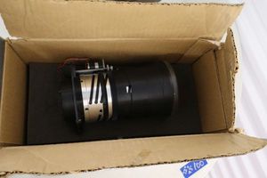 lot 105 image: Projector lens in EIKI box