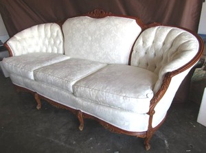 lot 506 image: Victorian style Chantelle button tufted sofa with ornate wood trim throughout (Matches chair in lot 507)