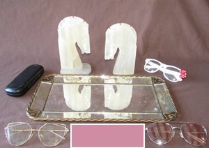 lot 519 image: Soapstone horse head book ends (one is missing base plate), plus mirrored make up tray and reading glasses
