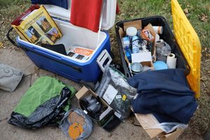 lot 137 image: Air mattress, outdoor solar lights, plastic cutlery, coffee bar supplies, cooler, and blankets