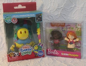 lot 21 image: Piata Smashlings Dazzle Donkey action figure. And Barbie little people unopened