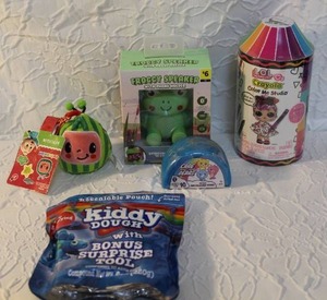 lot 32 image: Mixed lot Kiddy Dough and LOL Crayola color me studio and froggy speaker phone holder and care bear toy and cocomelon squishy all unopened