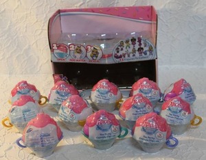 lot 39 image: Display with Alices Tea Party Cake Pop Cuties, which are a type of collectible toy. Each toy is a surprise figure hidden inside a cupcake-shaped container.