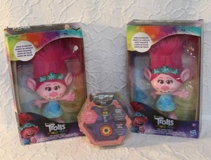 lot 41 image: 2-DreamWorks Trolls Pop Music Poppy Singing Doll. And Trolls World Tour Pods, which includes a Tiny Diamond mini-figure. Unopened