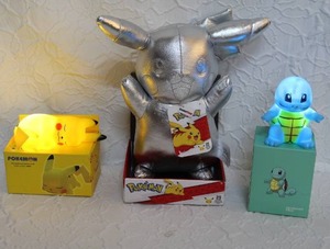 lot 44 image: Jazwares Pokmon Celebration Silver Pikachu Plush.  And 2-Pokmon night lights Open for pic.
