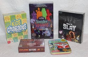 lot 116 image: Mixed lot of unopened games like here to slay sinister spoons game kids charades and more see pictures