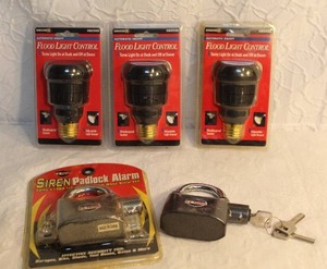 lot 178 image: 2-Siren Padlock Alarm, also known as a Kinbar Alarm Lock. And 3-Hemco OLC5CFLBC-4 150-Watt Outdoor Flood Light Control.