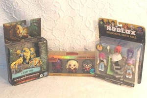lot 201 image: Harley Quinn, and Peacemaker.  Transformer toy and Roblox toy all unopened