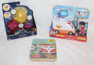 lot 231 image: Disney Wish Playful Light-Up Star & Yarn Accessories set.  And Disney Junior Firebuds Violet and Axl Figure and Ambulance Vehicle Set.  And a travel bingo set all unopened