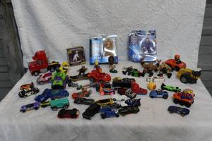lot 312 image: Mixed lot of toys unopened Spider-Man toys and Godzilla and a hand full of previously love toys