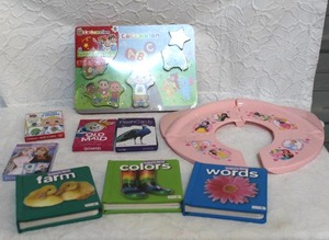lot 348 image: Cocomelon puzzle flash cards and card games kids books and a travel potty seat all unused or unopened