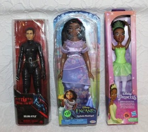 lot 353 image: Disney Princess Ballerina Tiana fashion doll  and Disney Encanto Isabela Madrigal fashion doll.  And Spin Master Selina Kyle action figure