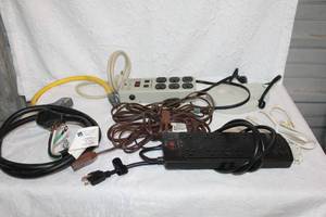 lot 364 image: Surge protectors and extension cords and a washer plug