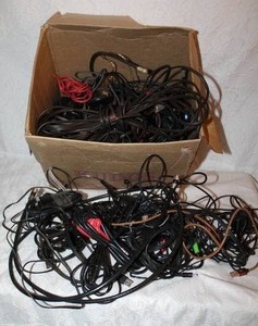 lot 404 image: Box full of speaker wire random wire plugs a mix of things
