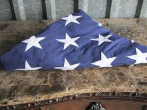 lot 50 image: FOLDED AMERICAN FLAG and American flag photo frame