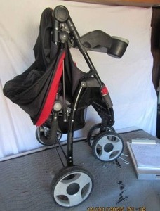 lot 105 image: EDDIE BOWER FOLDABLE STROLLER WITH STORAGE AND LOCKING WHEELS