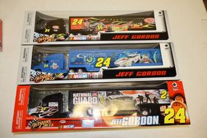 lot 64 image: Jeff Gordon 164 scale Trailer rigs - 3 total still in packaging