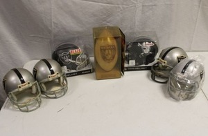 lot 97 image: Oakland Raiders mini helmets and Engraved solid wood football