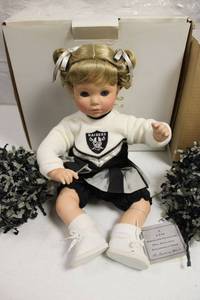 lot 98 image: Porcelain Oakland Raiders cheerleader doll
