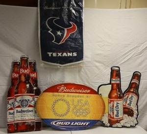 lot 127 image: Budweiser metal signs and Houston Texans flag