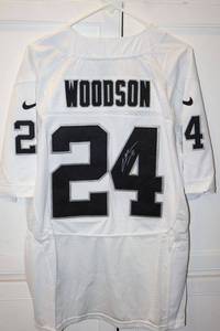 lot 129 image: Woodson #24 jersey (has signature- dont know if its printed or authentic, please preview). Still has tags.