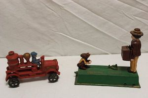 lot 136 image: Cast iron coin bank and tractor