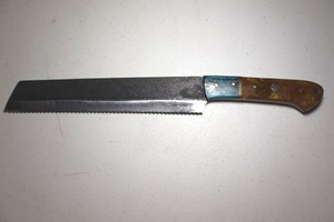 lot 260 image: 9 blade serrated narrow cleaver knife.  Wood and resin handle.