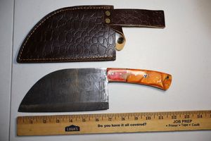 lot 264 image: 7 blade meat cleaver with leather sheath.  Wood and resin handle.