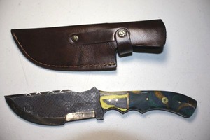 lot 266 image: 5 blade Tactical style knife with leather sheath.  Colored wood handle.