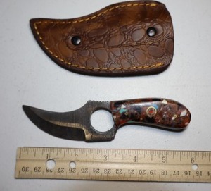 lot 269 image: 2.25 blade Skinner knife with finger hole.  Leather sheath.  Resin handle.