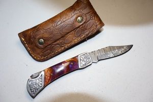 lot 72 image: Folding pocket knife with sheath