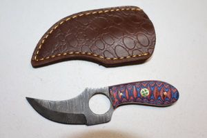 lot 208 image: Skinning knife with finger hole and sheath