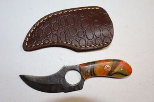lot 209 image: Skinning knife with finger hole and sheath