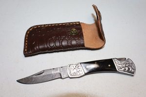 lot 236 image: Folding pocket knife with sheath