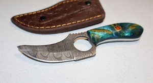 lot 282 image: Skinning knife with finger hole and sheath