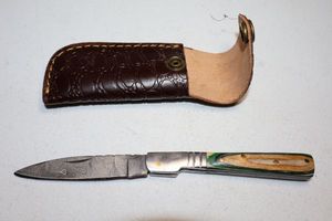 lot 297 image: Folding pocket knife with sheath