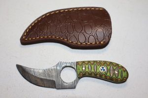 lot 391 image: Skinning knife with finger hole and sheath