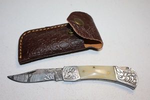 lot 396 image: Folding pocket knife with sheath
