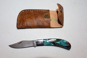 lot 329 image: Folding pocket knife with sheath