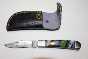 lot 332 image: Folding pocket knife with sheath
